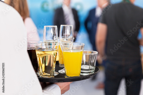Waiter carrying a tray with drinks at a party