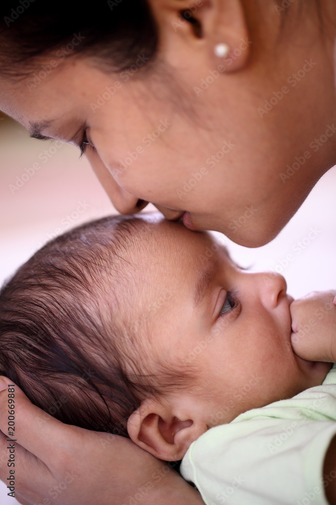 Cheerful mother holding newborn baby Cheerful mother holding newborn baby