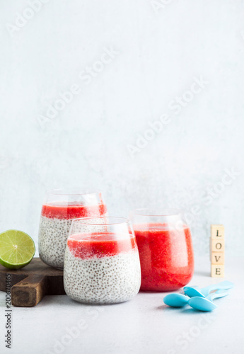 morning breakfast desserts in glasses. pudding from seeds of chia and coconut milk and puree from ripe strawberry. a light summer snack for children or athletes. Dietary healthy food.