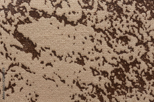 Mottled fabric texture with light brown surface.