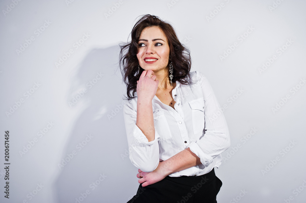 Studio portrait of brunette girl in white blouse on white background. Studio portrait of brunette girl in white blouse on white background.