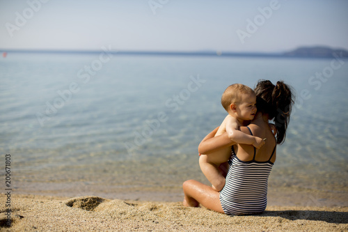 Cute little sisters sitting on a beach