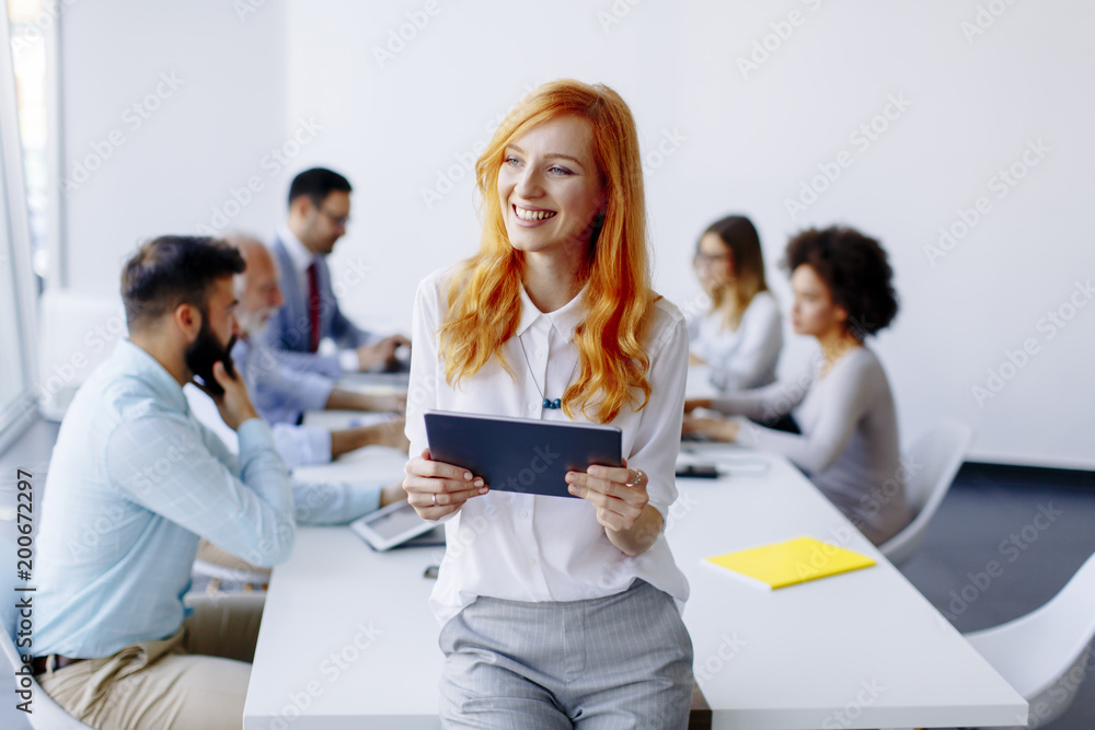 Pretty young red hair woman using digital tablet