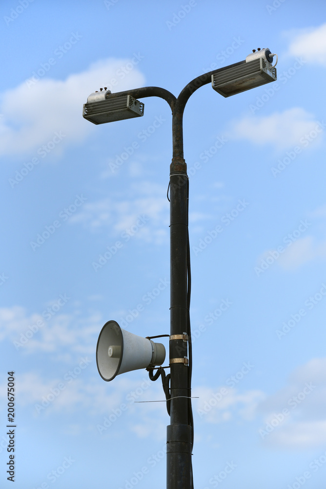 Pillar with street lights. Pillar with lanterns and loudspeaker or bullhorn, megaphone Pillar with street lights. Pillar with lanterns and loudspeaker or bullhorn, megaphone