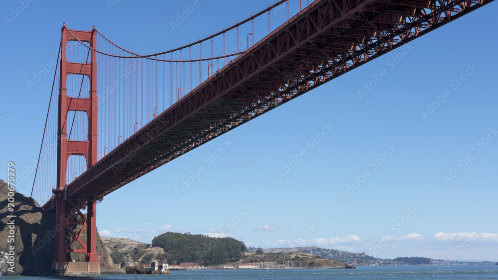 View towards the northern tower of Golden Gate Bridge, from beneath, on the Pacific Ocean side, captured from a ferryboat connecting Sausalito to San Francisco, California, USA View towards the northern tower of Golden Gate Bridge, from beneath, on the Pacific Ocean side, captured from a ferryboat connecting Sausalito to San Francisco, California, USA