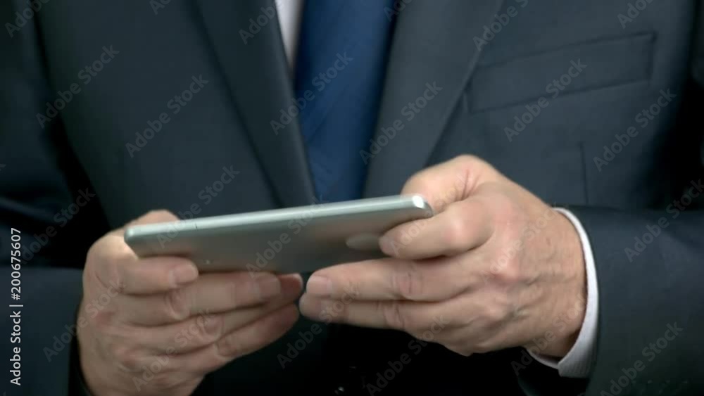Close up businessman using smartphone. Elderly man in formal wear playing game on mobile phone close up, chroma key background. Close up businessman using smartphone. Elderly man in formal wear playing game on mobile phone close up, chroma key background.