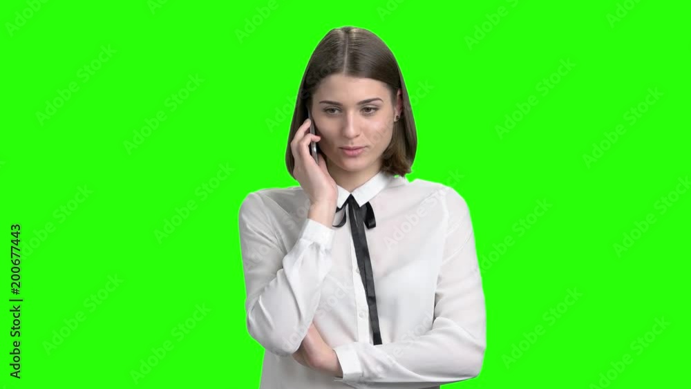 Portrait of sexy female clerk talking on phone. Explaining and consulting. Woman in white blouse talking with someone using smartphone. Portrait of sexy female clerk talking on phone. Explaining and consulting. Woman in white blouse talking with someone using smartphone.