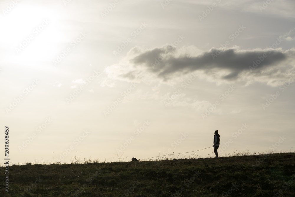 People on the horizon of meadow during sunset. Slovakia People on the horizon of meadow during sunset. Slovakia