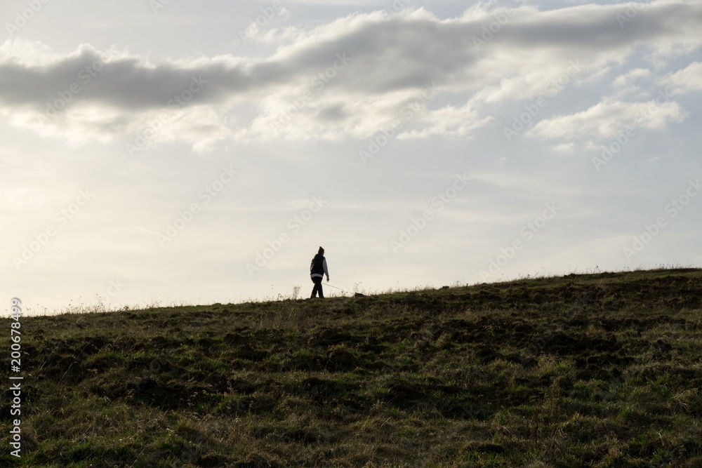 People on the horizon of meadow during sunset. Slovakia