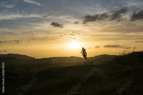 Motorcyclist riding off road during sunset. Slovakia