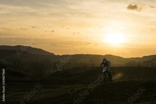 Motorcyclist riding off road during sunset. Slovakia © Valeria