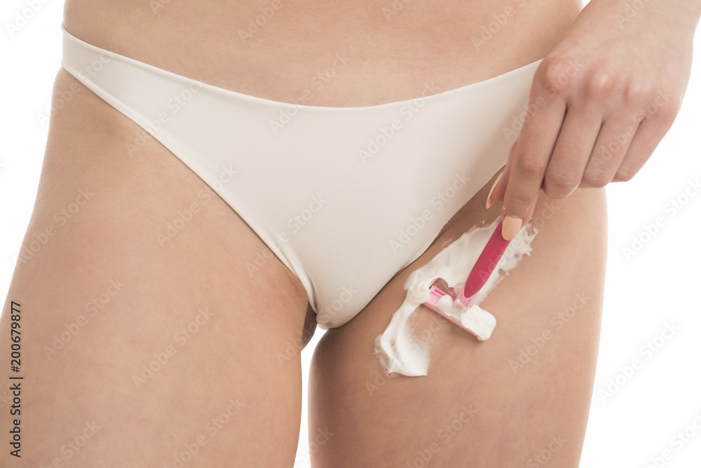woman shaves her crotch with a razor Stock Photo