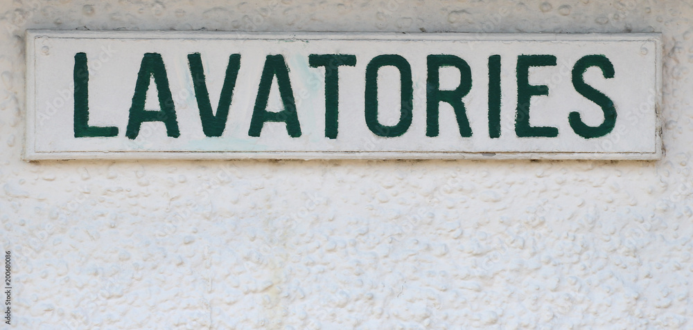 Obraz premium Old Public Toilet Sign in a Seaside Resort