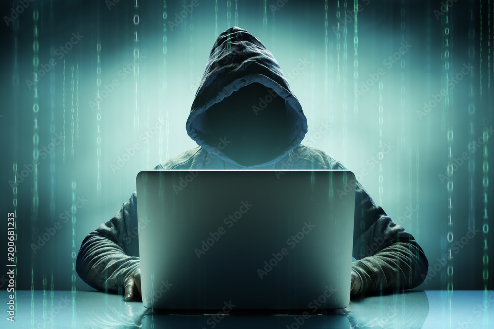 Fototapeta Anonimowy haker komputerowy z laptopem