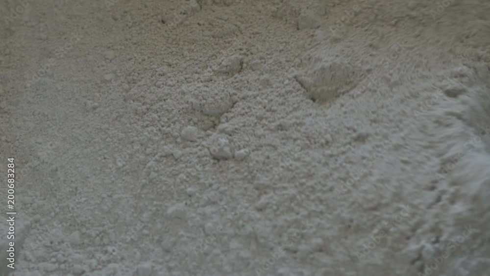 Slow motion handheld shot of mixing concrete plaster with electric mixer Slow motion handheld shot of mixing concrete plaster with electric mixer
