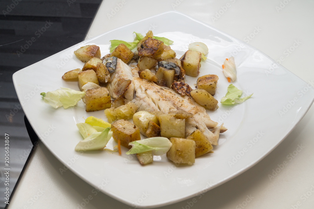 sea bass in the dish with potatoes and salad sea bass in the dish with potatoes and salad