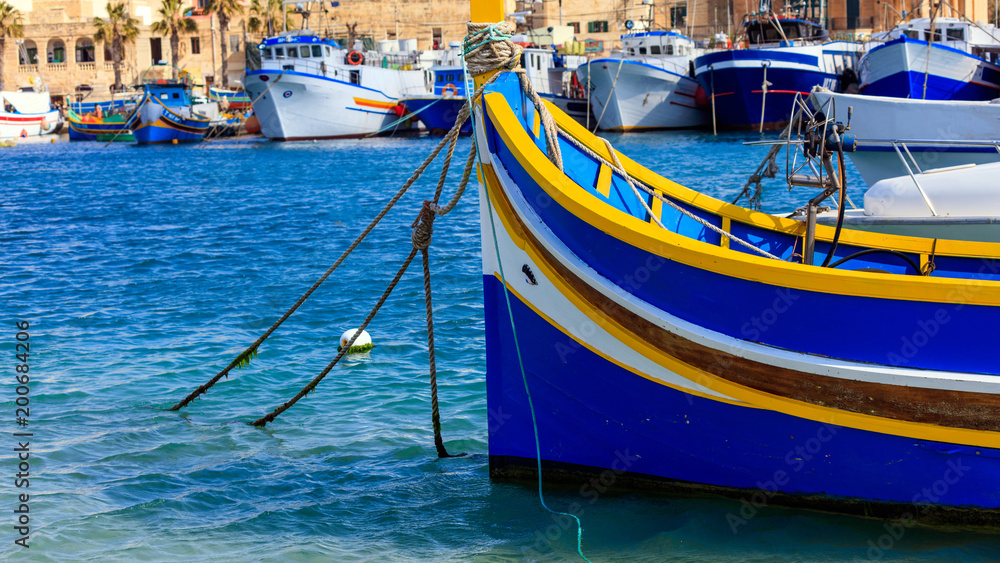 Traditional colorful boat luzzu at the port of Marsaxlokk, Malta. Closeup view