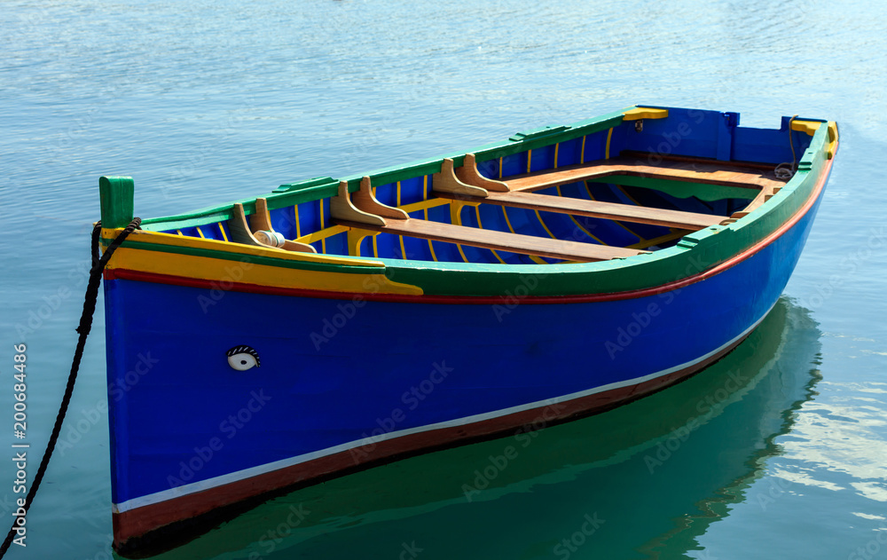 Traditional colorful boat luzzu at the port of Marsaxlokk, Malta. Closeup view