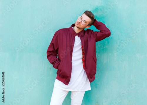 fashion guy standing posing near blue wall