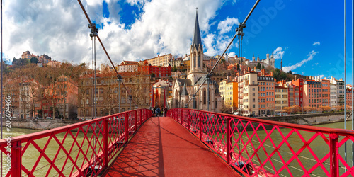 Panoramic view of Saint Georges church and pedestrian footbridge across Saone river, Old town with Fourviere cathedral in the sunny day in Lyon, France photo