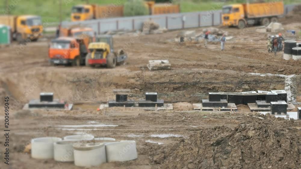 Preparation of soil for foundation laying on the construction site. Alignment of surface for erection of large complex of buildings Preparation of soil for foundation laying on the construction site. Alignment of surface for erection of large complex of buildings