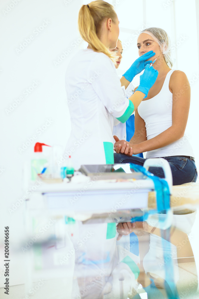 Obraz premium Beautiful woman face near doctor with syringe.