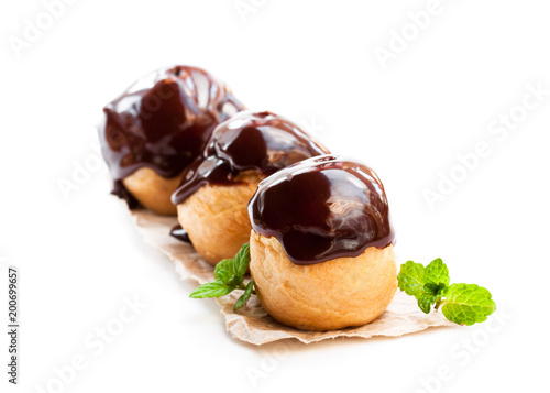 Photos Homemade  chocolate profiteroles isolated on white