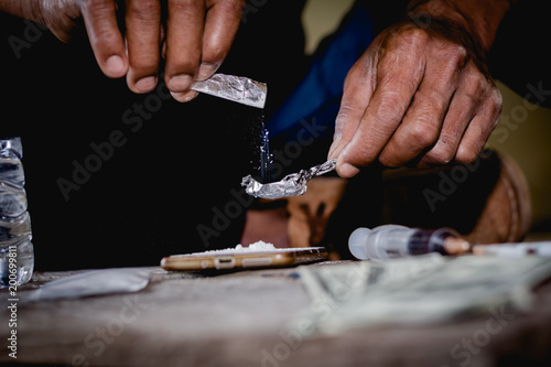 Closeup man using heroin. Narcotic overdose.man addict using cocaine drugs.Drug heroin addiction.Drug abuse concept,