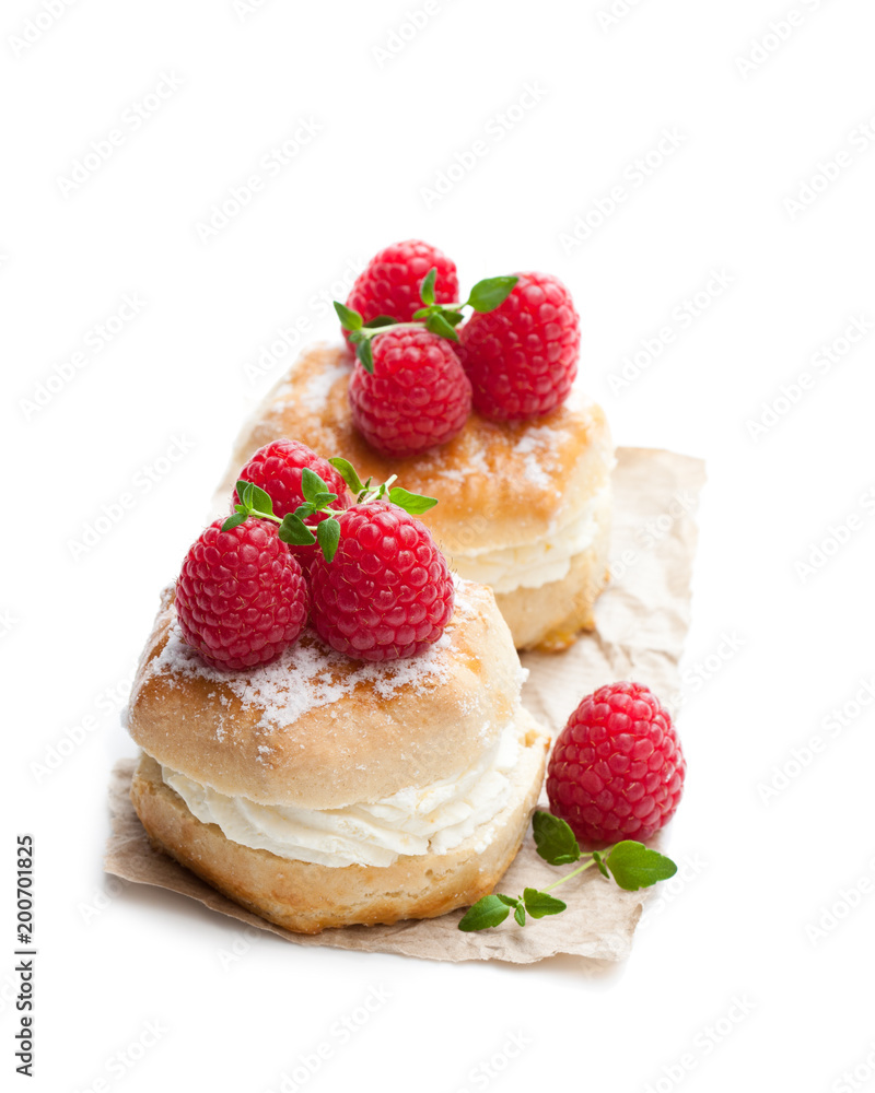 Traditional scones with raspberry and cream isolated on white Traditional scones with raspberry and cream isolated on white