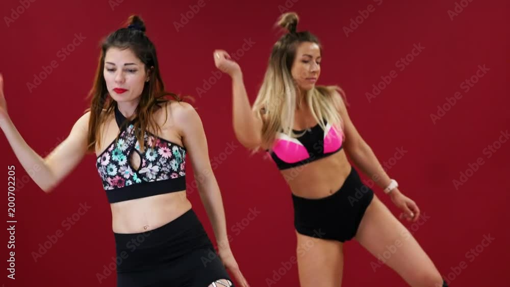 Two beautiful sports girls perform an active fat-burning workout jumping like a kangaroo in special fitness shoes. Cardio workout for endurance. kango jump Two beautiful sports girls perform an active fat-burning workout jumping like a kangaroo in special fitness shoes. Cardio workout for endurance. kango jump