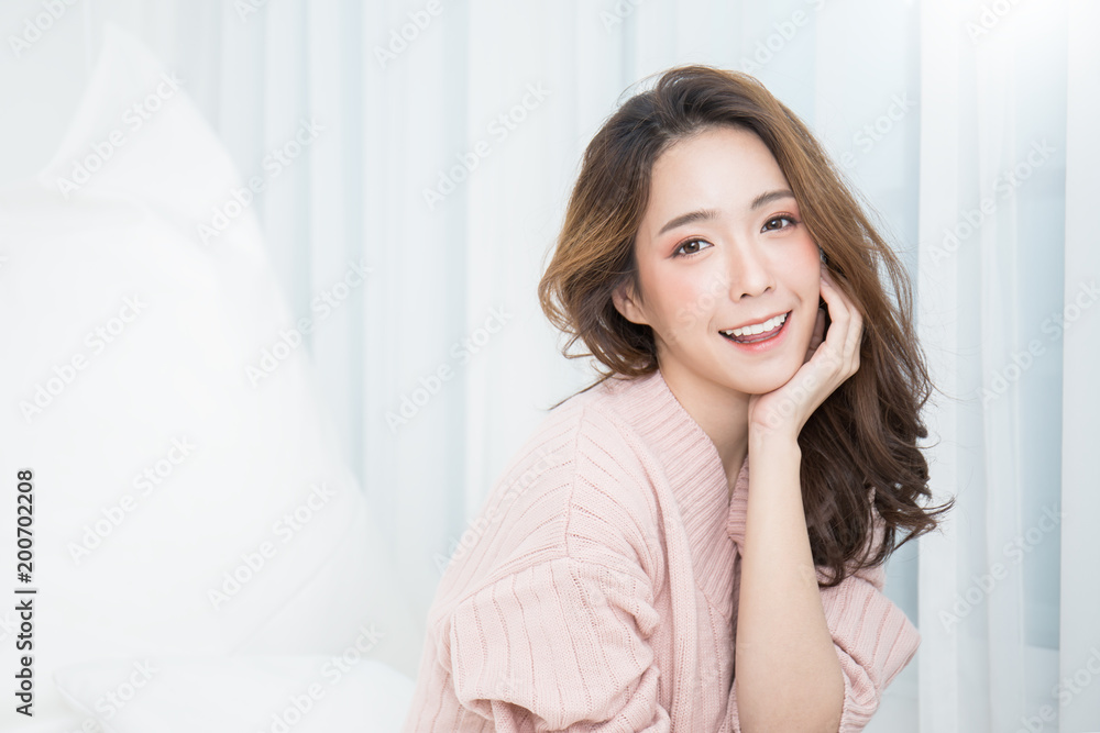 Portrait of young beautiful asian woman relax in her bedroom. Smile happy asian girl isolated on white background. Portrait of young beautiful asian woman relax in her bedroom. Smile happy asian girl isolated on white background.