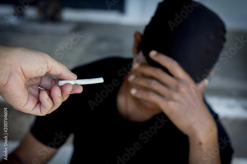 No smoking. Close up of male hands holding cigarettes and proposing it to person. Isolated on background