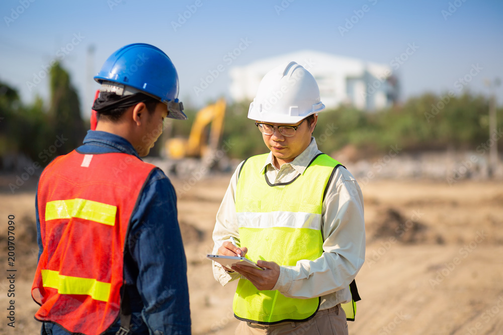 Construction engineer and foreman worker checking construction site for new Infrastructure construction project Construction engineer and foreman worker checking construction site for new Infrastructure construction project