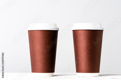 Takeout coffee cup on white. Brown paper cups isolated.