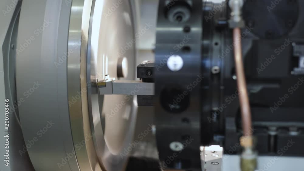 Machining of a metal part on a CNC lathe. Machining of a metal part on a CNC lathe.