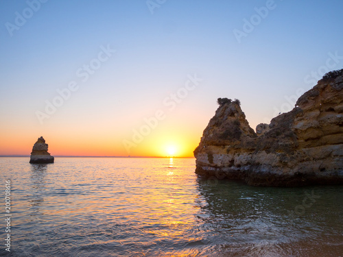 Beautiful landscape with amazing sunrise on the rocky atlantic ocean coast within the Lagos, Portugal.