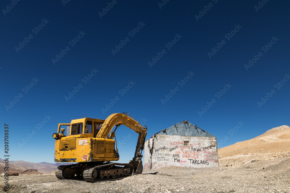 Excavator or large backhoe waiting for demolishing an abandon building