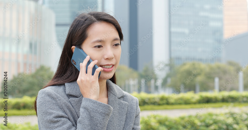 Businesswoman talk to mobile phone at outdoor Businesswoman talk to mobile phone at outdoor