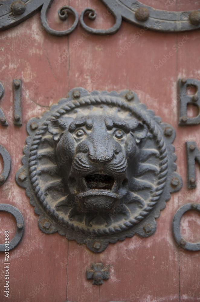 Metallischer Löwenkopf an einer schweren Kirchentür