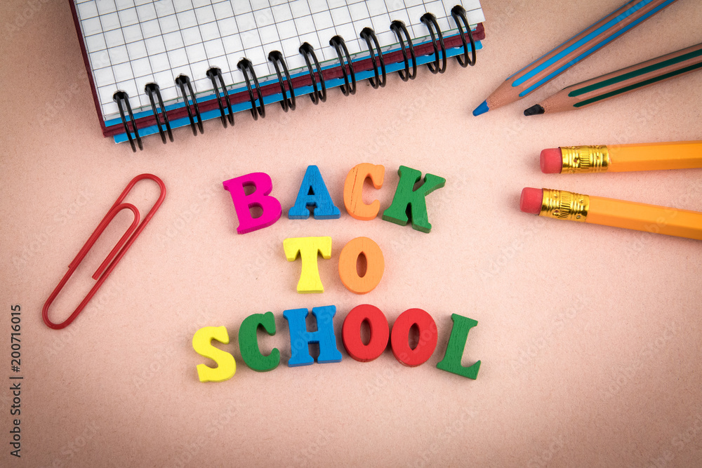 Back to school. Wooden letters on the office desk, informative and communication background Back to school. Wooden letters on the office desk, informative and communication background