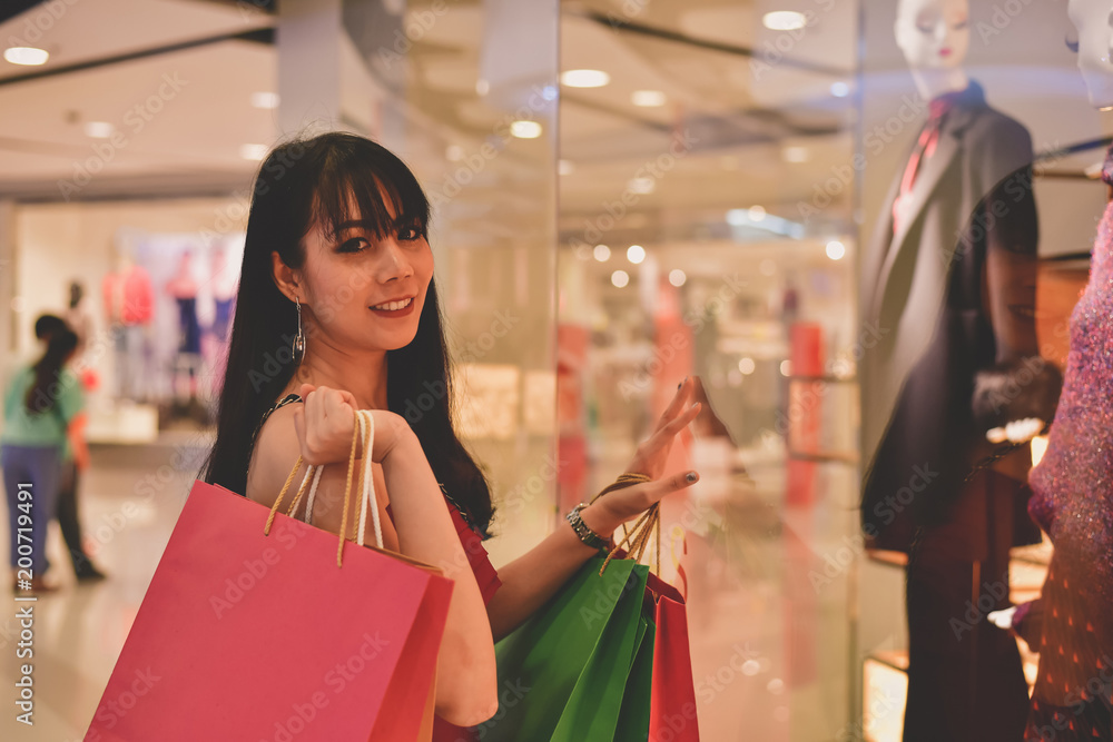 Shopping Concept. Asian girls are shopping in the mall. Beautiful women are happy to shop in the mall. Beautiful girl walking in the mall. Shopping Concept. Asian girls are shopping in the mall. Beautiful women are happy to shop in the mall. Beautiful girl walking in the mall.