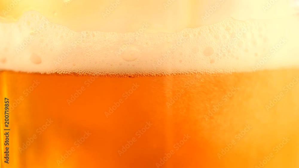 Detail of beer glass with bubbles. Close up beer background, slow motion. Detail of beer glass with bubbles. Close up beer background, slow motion.