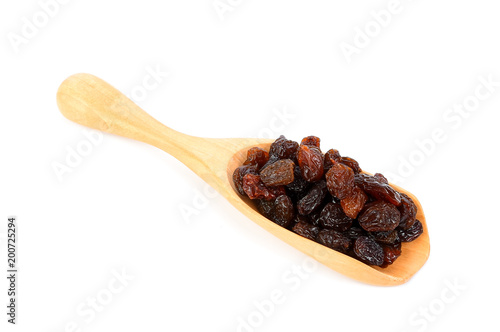 raisin on wood scoop isolated on white background