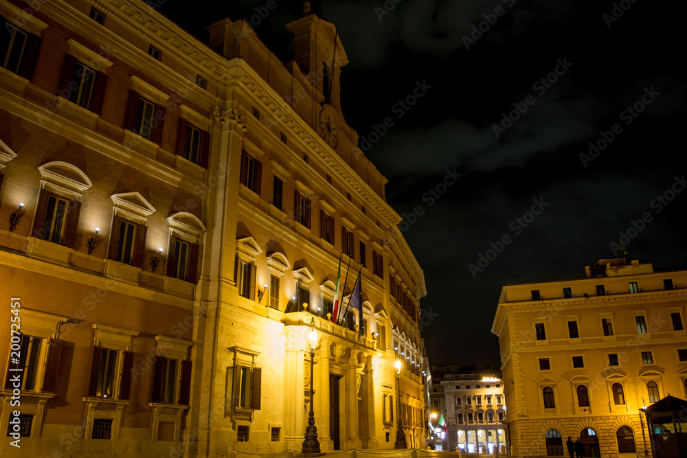 Horizontal View of the Italian Parliament Building, Montecitorio, at Night Illuminated by Warm Lights on Cloudy Night Sky Background. Rome, Italy