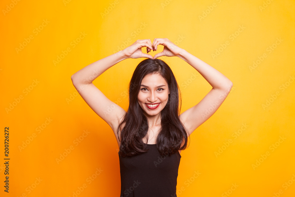 Young Asian woman show with phone gesture. Young Asian woman show with phone gesture.