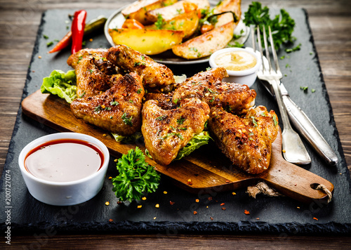 Roast chicken wings with baked potatoes