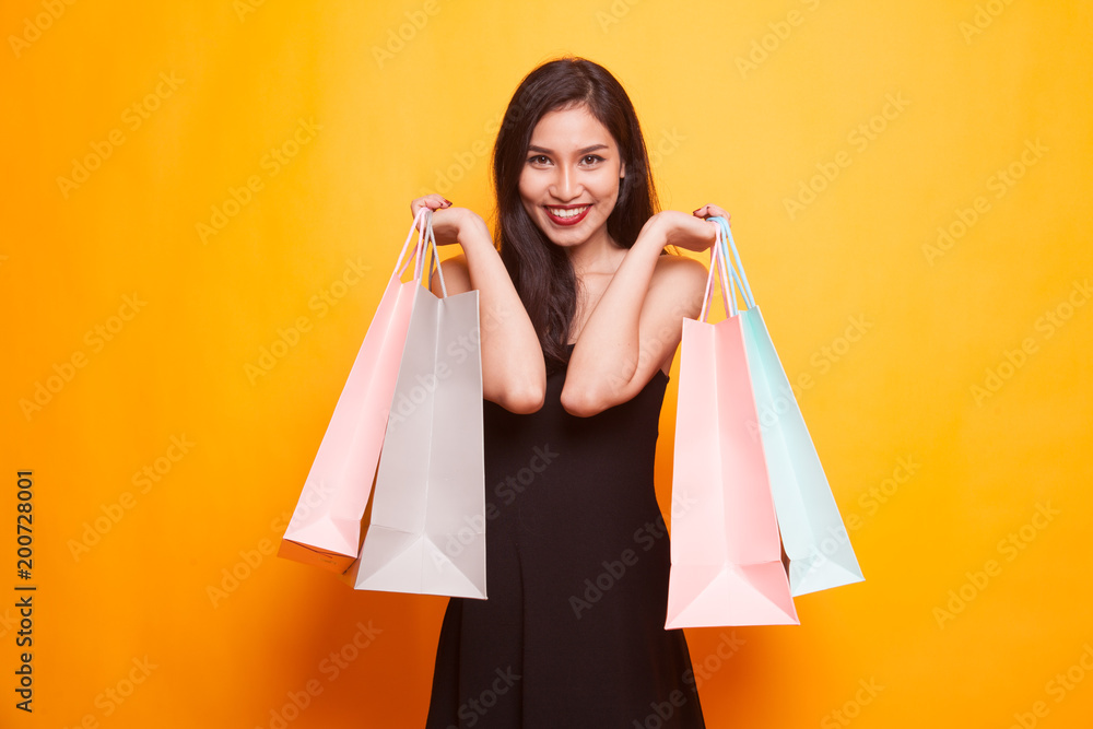 Beautiful young Asian woman with shopping bags.