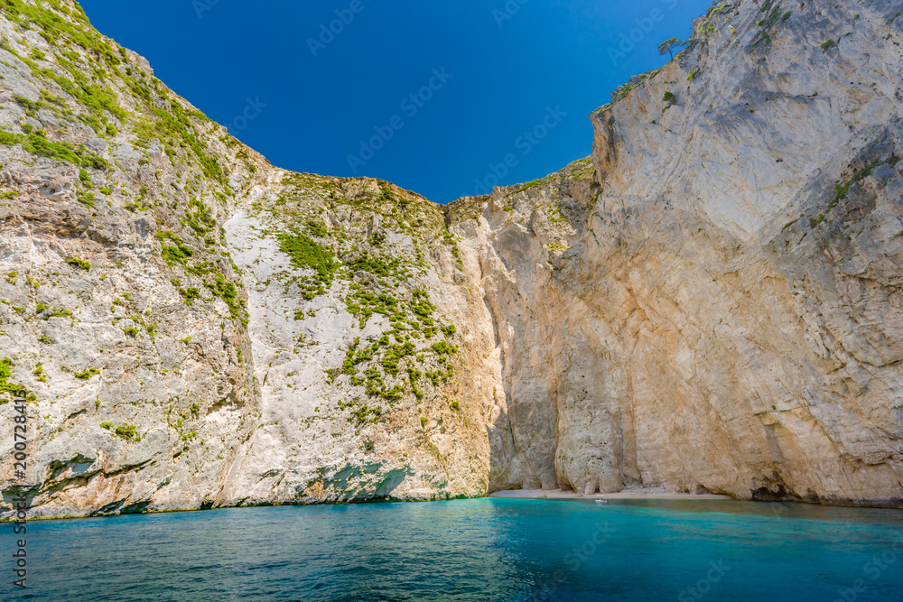 Greece island white cliffs and blue sea.