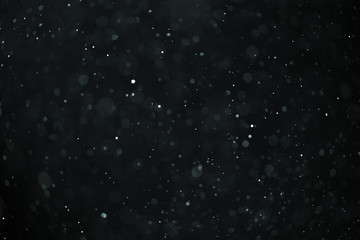 abstract real dust floating over black background for overlay