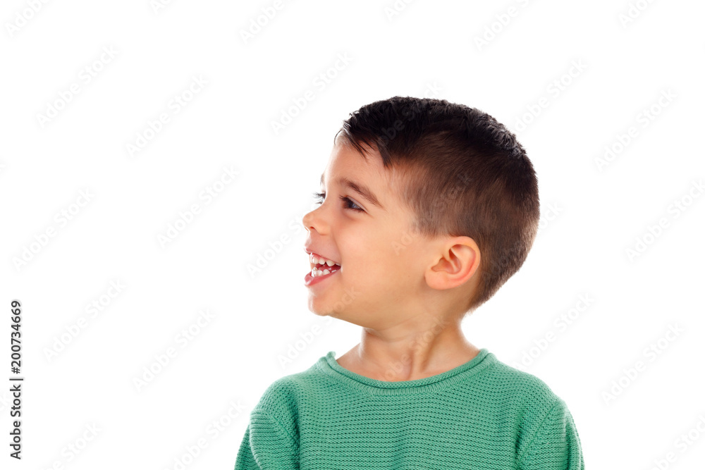 Pensive child with green t-shirt looking up Pensive child with green t-shirt looking up